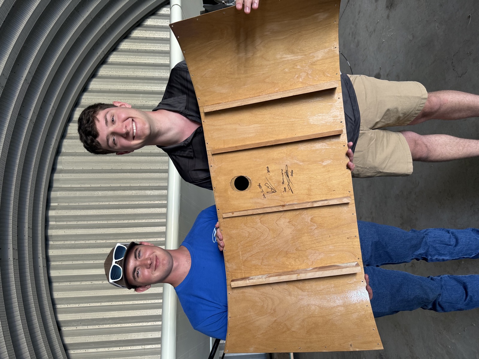 Joe and Josh signing a wing panel of the Super Koala build, 2026